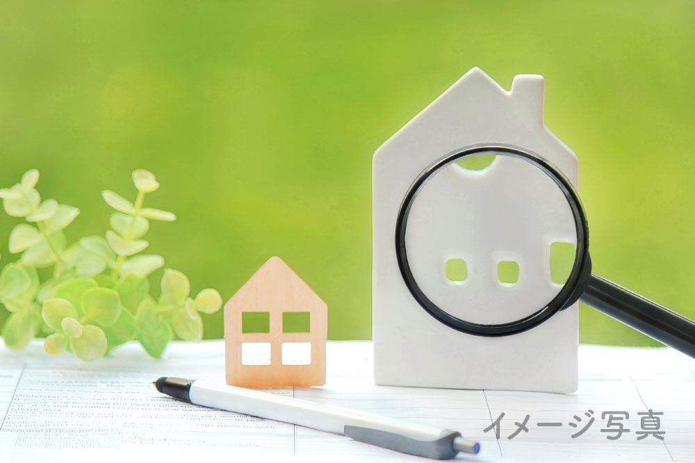 家の模型とルーペの画像